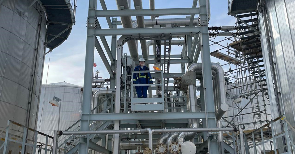 Lauren Coombs on the slop tank berm platform in Foster Creek