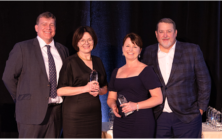 Lesley Desjardins and Megan McVey accepting their President's Award.