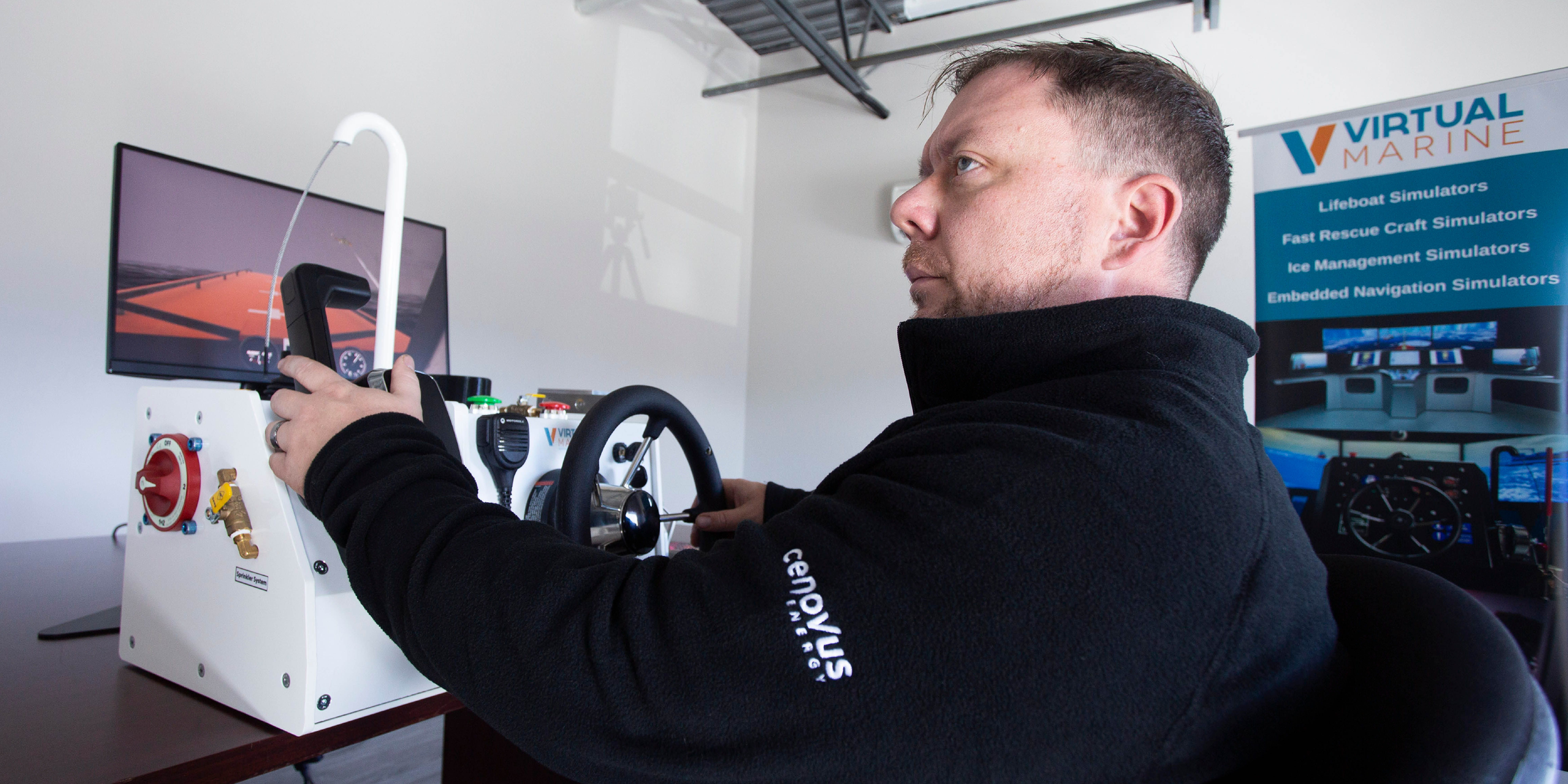 A man demonstrates a scenario using a simulator at Virtual Marine. 