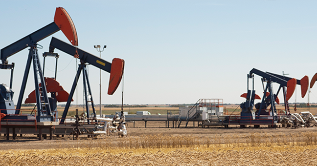 Two pump jacks in a field